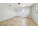 Bright bedroom with neutral walls and vinyl plank flooring, creating a clean and simple look at 5810 8Th Ave, New Port Richey, FL 34652