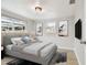 The gray bedroom is filled with natural light, art, and a wall-mounted tv at 5810 8Th Ave, New Port Richey, FL 34652