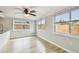 Well-lit dining room with two windows, wood flooring, and a modern ceiling fan at 5810 8Th Ave, New Port Richey, FL 34652
