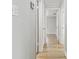 Hallway with wood-look flooring and multiple doors showcasing the home's layout at 5810 8Th Ave, New Port Richey, FL 34652