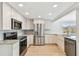 Modern kitchen featuring stainless steel appliances, white cabinets, and granite countertops at 5810 8Th Ave, New Port Richey, FL 34652