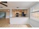 Open kitchen view with a breakfast bar featuring granite counters and modern stainless steel appliances at 5810 8Th Ave, New Port Richey, FL 34652