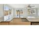 Bright kitchen sink featuring granite counters, an updated faucet, and three windows with wooded views at 5810 8Th Ave, New Port Richey, FL 34652
