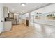 Open kitchen and living area with stainless steel appliances and hardwood floors at 5810 8Th Ave, New Port Richey, FL 34652