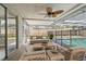 Relax in this airy lanai with screened enclosure, furniture, and a ceiling fan overlooking the pool at 5810 8Th Ave, New Port Richey, FL 34652