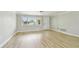 Living room featuring hardwood floors and natural light from a large window at 5810 8Th Ave, New Port Richey, FL 34652