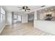 Open living space features wood-look floors and connects to the kitchen and outdoor patio at 5810 8Th Ave, New Port Richey, FL 34652