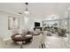 Open-concept dining and living area with hardwood floors, stylish furniture, and ample natural light at 5810 8Th Ave, New Port Richey, FL 34652