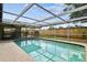 Enjoy swimming in the screened-in pool and backyard at 5810 8Th Ave, New Port Richey, FL 34652
