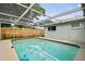 Relaxing backyard pool with screened enclosure, blending comfort and style at 5810 8Th Ave, New Port Richey, FL 34652
