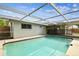 Private pool featuring a screened enclosure and easy access to the home's interior at 5810 8Th Ave, New Port Richey, FL 34652