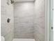Close-up view of the modern shower featuring gray tiled walls at 5810 8Th Ave, New Port Richey, FL 34652
