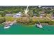 Aerial view of waterfront property with lush landscaping, docks and serene inlet at 636 Sunset S Dr, St Petersburg, FL 33707