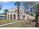 Charming stucco home with arched entryways, a mature palm tree, and a well-maintained lawn at 636 Sunset S Dr, St Petersburg, FL 33707