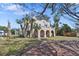 Stately home featuring arched porch, palm trees, and classic architectural detailing on a sunny day at 636 Sunset S Dr, St Petersburg, FL 33707