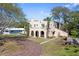 Beautiful home with arched entryways, a well-manicured lawn, and brick driveway at 636 Sunset S Dr, St Petersburg, FL 33707
