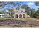 Beautiful home with arched entryways, a well-manicured lawn, and brick driveway at 636 Sunset S Dr, St Petersburg, FL 33707