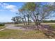 Landscaped front yard with mature trees and brick-paved circular driveway provides ample parking at 636 Sunset S Dr, St Petersburg, FL 33707