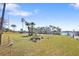Expansive waterfront property with mature palm trees and lush grass near a dock at 636 Sunset S Dr, St Petersburg, FL 33707