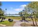 Street view with waterfront access and brick driveway in tropical setting at 636 Sunset S Dr, St Petersburg, FL 33707