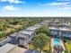 A beautiful aerial view of the condos, showcasing a community pool and meticulously maintained landscaping at 8765 Bardmoor Blvd # 107, Seminole, FL 33777