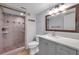 Updated bathroom featuring a tiled shower, a new vanity with a gray cabinet and white countertop at 8765 Bardmoor Blvd # 107, Seminole, FL 33777