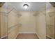 Walk-in closet featuring wire shelving with tile floors and mirrored walls at 8765 Bardmoor Blvd # 107, Seminole, FL 33777