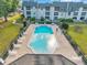 Aerial view of a sparkling community pool with lounge chairs and well-maintained landscaping at 8765 Bardmoor Blvd # 107, Seminole, FL 33777