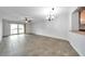 Open concept living room featuring tile floors and a sliding glass door to the backyard at 8765 Bardmoor Blvd # 107, Seminole, FL 33777