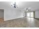 Spacious living room with tile flooring, a ceiling fan, and sliding glass doors to the backyard at 8765 Bardmoor Blvd # 107, Seminole, FL 33777