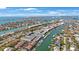Stunning aerial view of a waterfront community with canals, boats, and city skyline in the background at 903 Pinellas Bayway S # 308, Tierra Verde, FL 33715