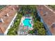Aerial view of the community pool surrounded by lush landscaping and residential buildings at 903 Pinellas Bayway S # 308, Tierra Verde, FL 33715