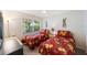 Bright bedroom featuring two twin beds and an exterior view of the tree-lined property at 903 Pinellas Bayway S # 308, Tierra Verde, FL 33715