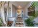 Charming home entrance with decorative glass front door and lovely landscaping at 903 Pinellas Bayway S # 308, Tierra Verde, FL 33715