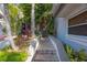Inviting entrance with landscaped walkway and front door at 903 Pinellas Bayway S # 308, Tierra Verde, FL 33715