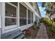 Exterior view of the screened lanai with a brick path and lush landscaping at 903 Pinellas Bayway S # 308, Tierra Verde, FL 33715