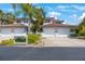 Exterior showing the two-car garage, well-manicured landscaping, and red tile roof at 903 Pinellas Bayway S # 308, Tierra Verde, FL 33715