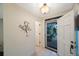 Bright foyer featuring tile flooring, an open doorway, and decorative accents at 903 Pinellas Bayway S # 308, Tierra Verde, FL 33715