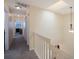 Bright hallway with neutral walls, carpet and a pendant light fixture at 903 Pinellas Bayway S # 308, Tierra Verde, FL 33715