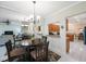 Open-concept living and dining area featuring tile floors, dining table, and mirrored wall at 903 Pinellas Bayway S # 308, Tierra Verde, FL 33715