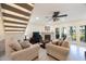 Cozy living room featuring tile floors, a fireplace, a ceiling fan, and staircase access at 903 Pinellas Bayway S # 308, Tierra Verde, FL 33715