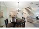 Inviting living room showcasing tile floors, a round dining table, and open access to the kitchen at 903 Pinellas Bayway S # 308, Tierra Verde, FL 33715