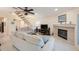 Comfortable living room featuring tile floors, a fireplace, a ceiling fan, and staircase access at 903 Pinellas Bayway S # 308, Tierra Verde, FL 33715