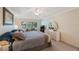 Bright main bedroom offers a plush bed, ceiling fan, ample closet space, and a cozy seating area at 903 Pinellas Bayway S # 308, Tierra Verde, FL 33715
