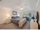 Serene main bedroom featuring a comfortable bed, couch, ceiling fan, and a view to the outside at 903 Pinellas Bayway S # 308, Tierra Verde, FL 33715