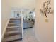 Staircase with white railings and carpeted steps leading to a bright living area at 903 Pinellas Bayway S # 308, Tierra Verde, FL 33715