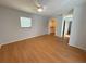 Bedroom featuring hardwood floors, closet, and neutral paint at 9304 Nile Dr, New Port Richey, FL 34655