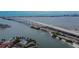 Stunning aerial view featuring a bridge, shoreline, and beautiful waterfront homes with private pools at 100 Bluff View Dr # 510A, Belleair Bluffs, FL 33770