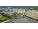 Aerial view of a condo complex with a pool, landscaped grounds, and waterfront access, showcasing the community at 100 Bluff View Dr # 510A, Belleair Bluffs, FL 33770