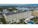 Multi-story building situated on the waterfront, with a pool and beautifully landscaped grounds at 100 Bluff View Dr # 510A, Belleair Bluffs, FL 33770